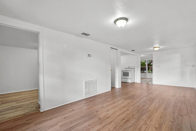 935 NE Sanchez Ave, Ocala, FL 34470 - unfurnished living room with wood finished floors, visible vents, and baseboards