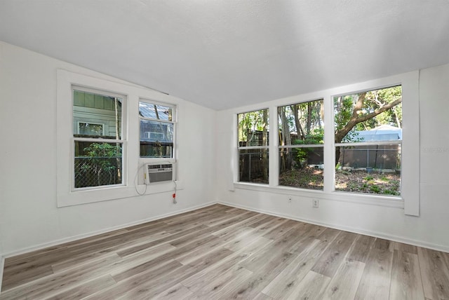 935 NE Sanchez Ave, Ocala, FL 34470 - unfurnished room featuring lofted ceiling, cooling unit, baseboards, and light wood-style floors