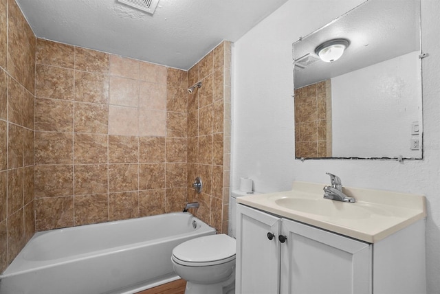 935 NE Sanchez Ave, Ocala, FL 34470 - full bath featuring visible vents, toilet, vanity,  shower combination, and a textured ceiling