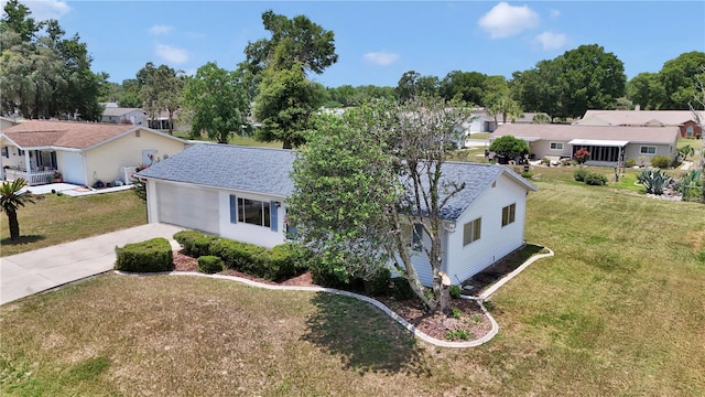 11118 SW 76th Ave, Ocala, FL 34476 - view of front of home with driveway, a front yard, a residential view, and roof with shingles