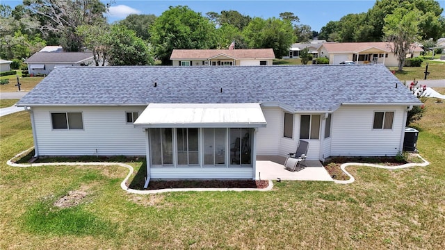 11118 SW 76th Ave, Ocala, FL 34476 - back of house with a patio area, a sunroom, a shingled roof, a yard, and central AC unit