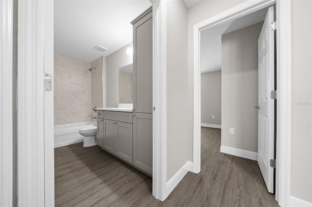 10435 SE 125th Ln, Belleview, FL 34420 - bathroom featuring baseboards, visible vents, vanity, shower / washtub combination, and wood finished floors