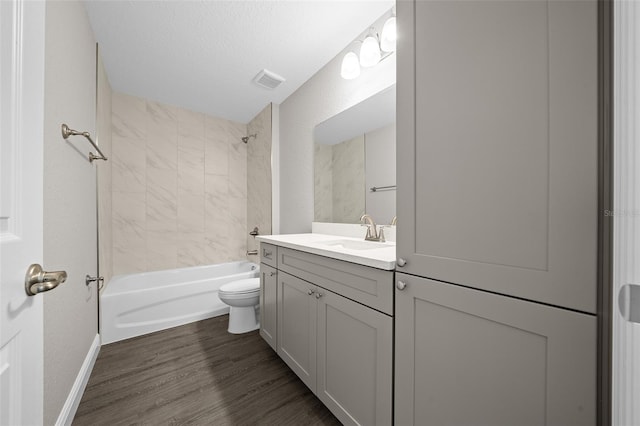 10435 SE 125th Ln, Belleview, FL 34420 - bathroom with toilet, wood finished floors, bathtub / shower combination, baseboards, and vanity