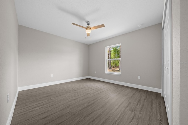 10435 SE 125th Ln, Belleview, FL 34420 - unfurnished bedroom with baseboards, dark wood finished floors, and ceiling fan