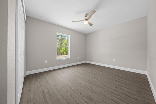 10435 SE 125th Ln, Belleview, FL 34420 - unfurnished room featuring a ceiling fan, baseboards, and dark wood-type flooring