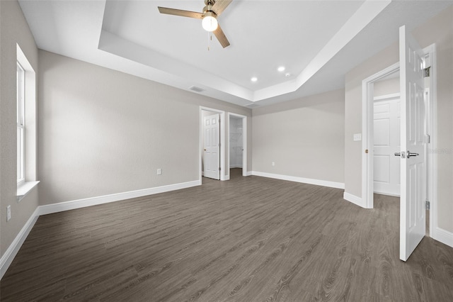 10435 SE 125th Ln, Belleview, FL 34420 - unfurnished bedroom featuring dark wood-type flooring, visible vents, recessed lighting, a raised ceiling, and baseboards