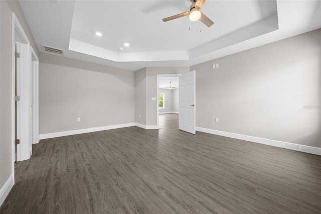 10435 SE 125th Ln, Belleview, FL 34420 - unfurnished bedroom with baseboards, a raised ceiling, visible vents, and dark wood-style floors