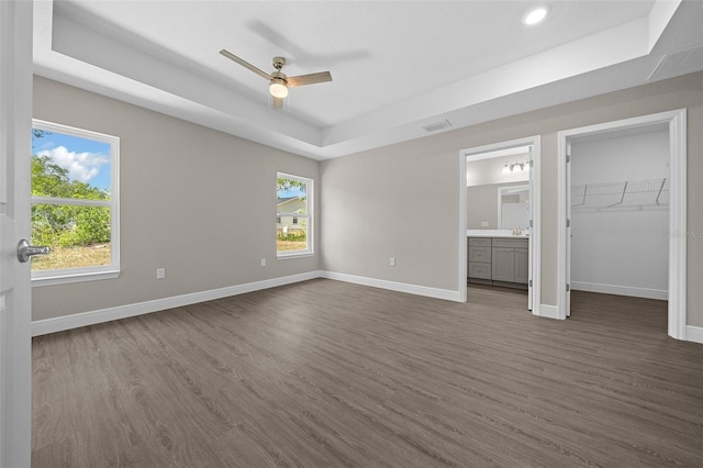 10435 SE 125th Ln, Belleview, FL 34420 - unfurnished bedroom featuring dark wood-type flooring, baseboards, a raised ceiling, and visible vents