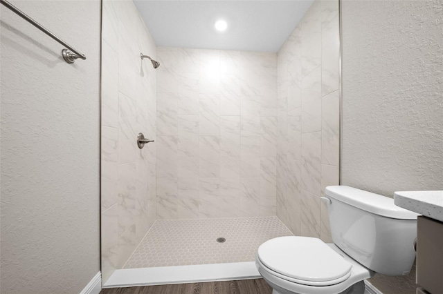 10435 SE 125th Ln, Belleview, FL 34420 - full bathroom with toilet, tiled shower, a textured wall, and wood finished floors
