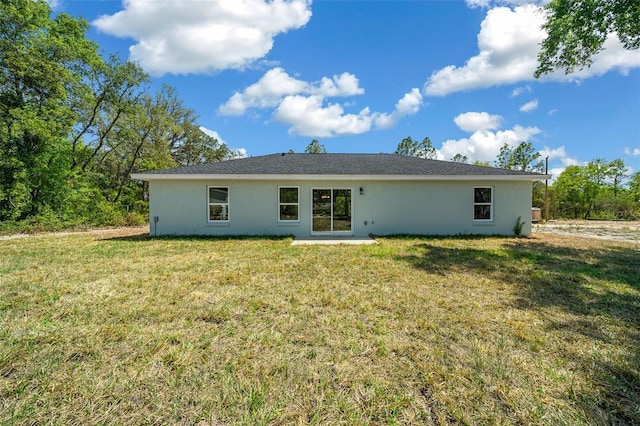 10435 SE 125th Ln, Belleview, FL 34420 - back of property featuring stucco siding and a lawn