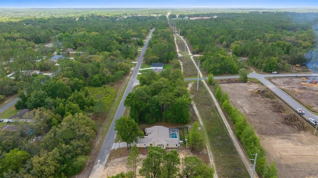 birds eye view of property featuring a wooded view