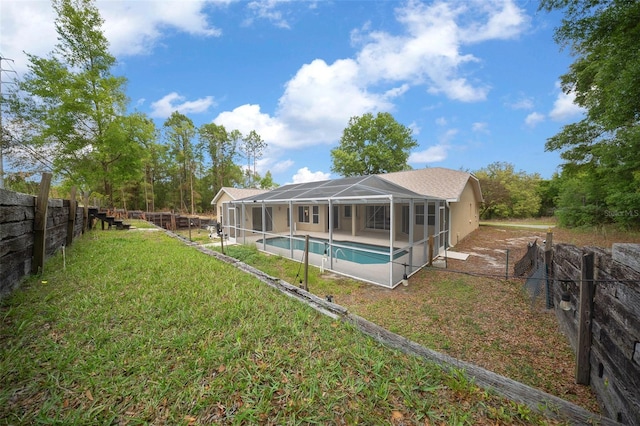 view of swimming pool featuring a lawn, a fenced backyard, glass enclosure, a patio, and a fenced in pool