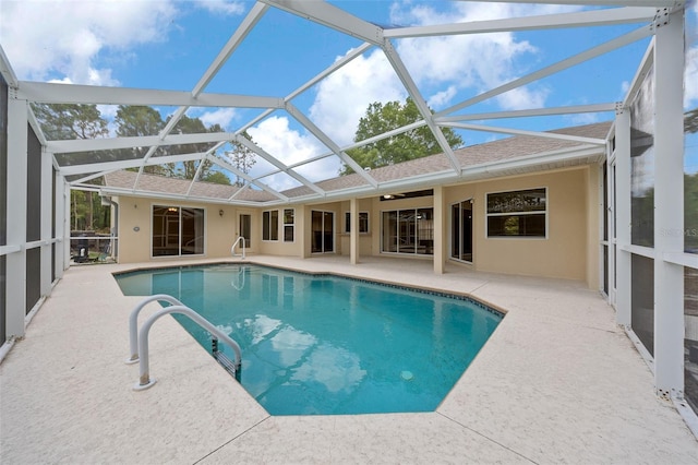 outdoor pool featuring a patio area, glass enclosure, and ceiling fan