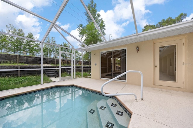 outdoor pool featuring a lanai, a patio, and fence