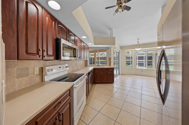 kitchen with tasteful backsplash, light countertops, appliances with stainless steel finishes, a ceiling fan, and light tile patterned flooring