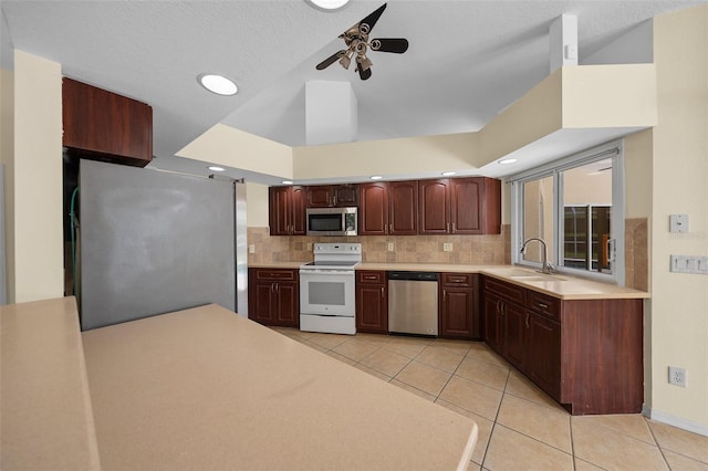 kitchen featuring a ceiling fan, light tile patterned flooring, light countertops, a sink, and stainless steel appliances
