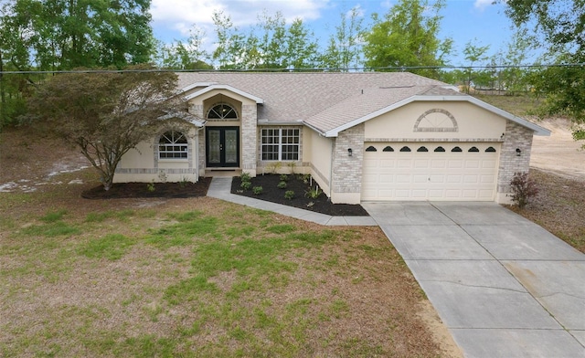 ranch-style house featuring a garage, roof with shingles, brick siding, french doors, and driveway