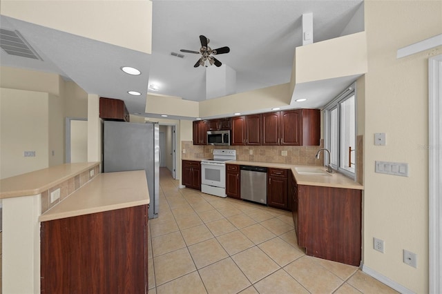 kitchen with ceiling fan, light tile patterned floors, a sink, stainless steel appliances, and decorative backsplash