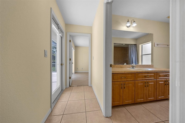 full bathroom featuring vanity, baseboards, and tile patterned flooring