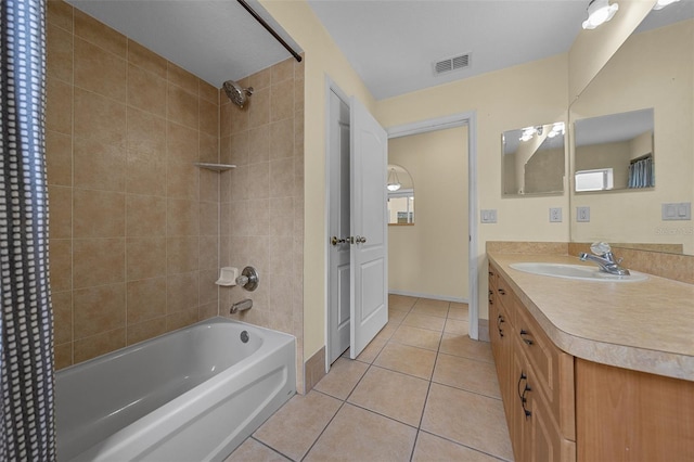 bathroom featuring visible vents, baseboards, shower / tub combination, vanity, and tile patterned floors