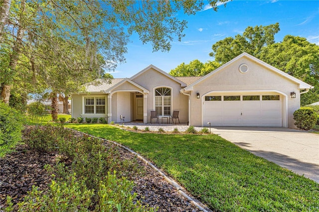 ranch-style house with a garage, concrete driveway, stucco siding, and a front lawn