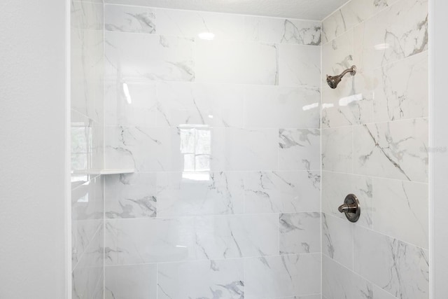 full bathroom with tiled shower