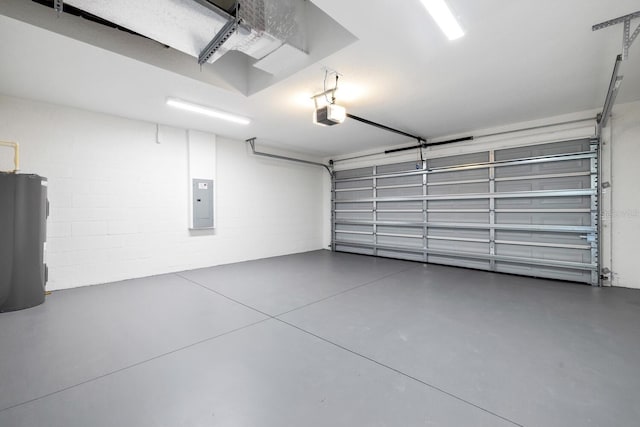 garage with water heater, concrete block wall, and a garage door opener