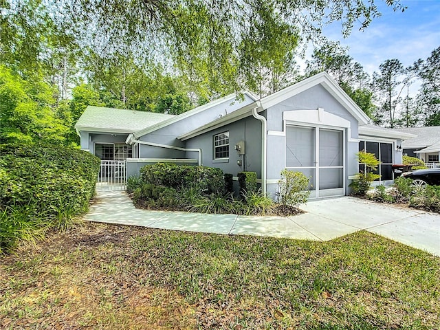 exterior space with an attached garage, concrete driveway, and stucco siding