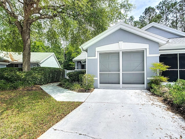 view of front of home with concrete driveway and an attached garage