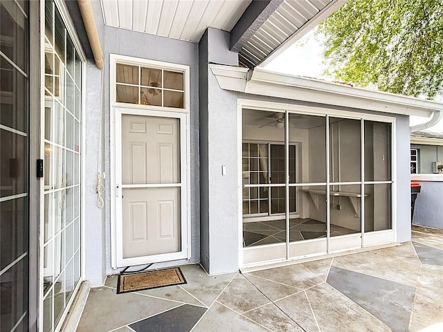doorway to property with stucco siding