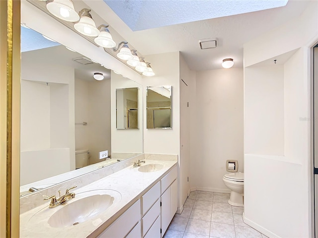 full bathroom with a sink, toilet, tile patterned flooring, and baseboards