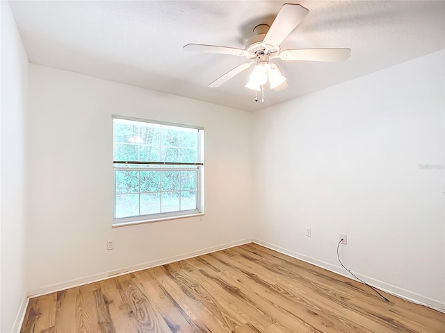 unfurnished room with baseboards, light wood-type flooring, and a ceiling fan