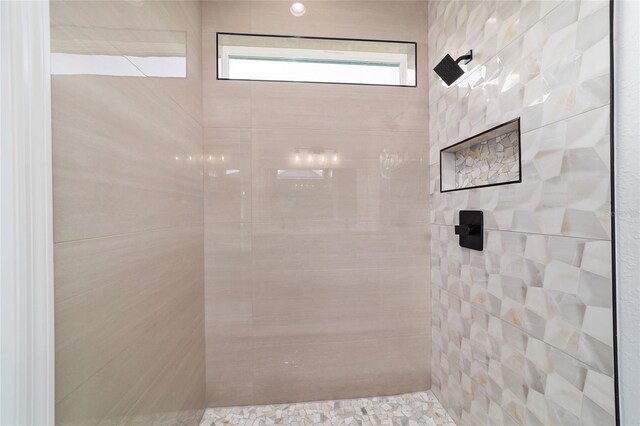 bathroom with tiled shower