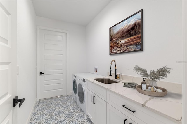clothes washing area featuring cabinet space, washing machine and dryer, light tile patterned floors, and baseboards