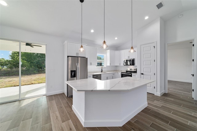 kitchen featuring stainless steel appliances, dark wood-type flooring, light stone countertops, baseboards, and recessed lighting