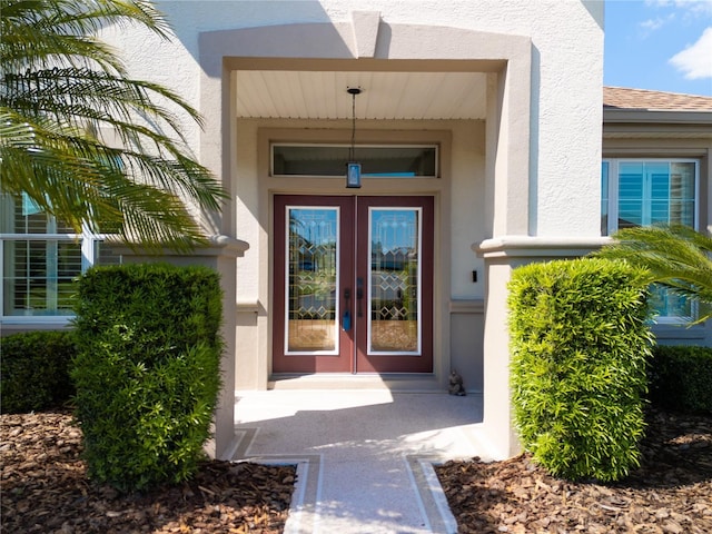 entrance to property featuring stucco siding
