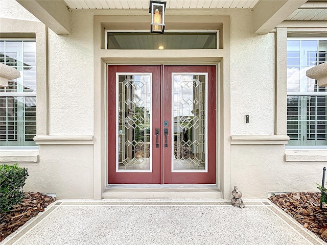 doorway to property with french doors and stucco siding