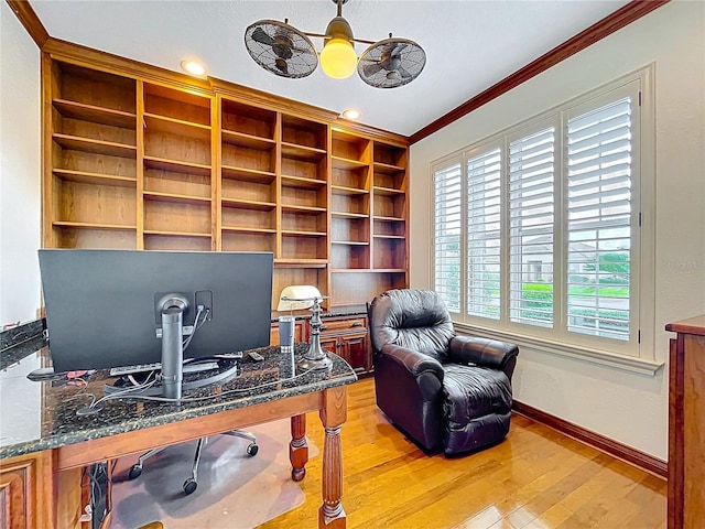 home office featuring crown molding, baseboards, light wood-type flooring, and built in shelves