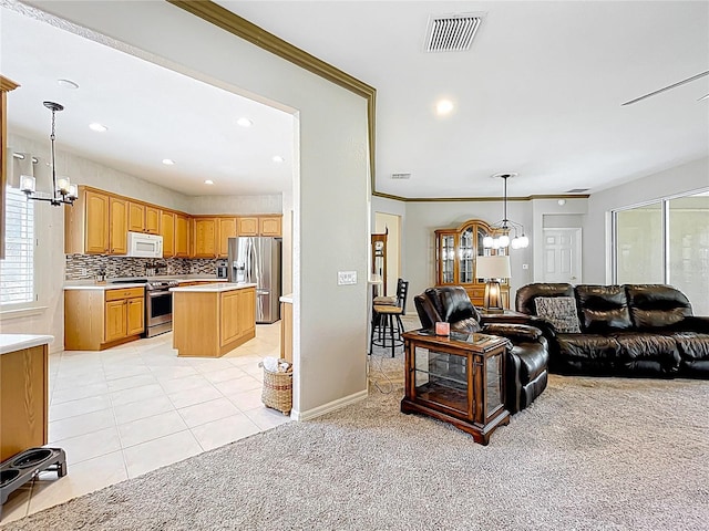 living room featuring visible vents, recessed lighting, an inviting chandelier, and light carpet