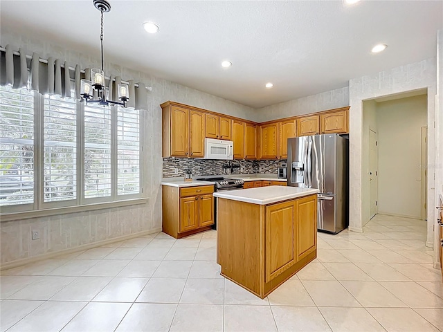 kitchen featuring light tile patterned floors, light countertops, a chandelier, recessed lighting, and stainless steel appliances