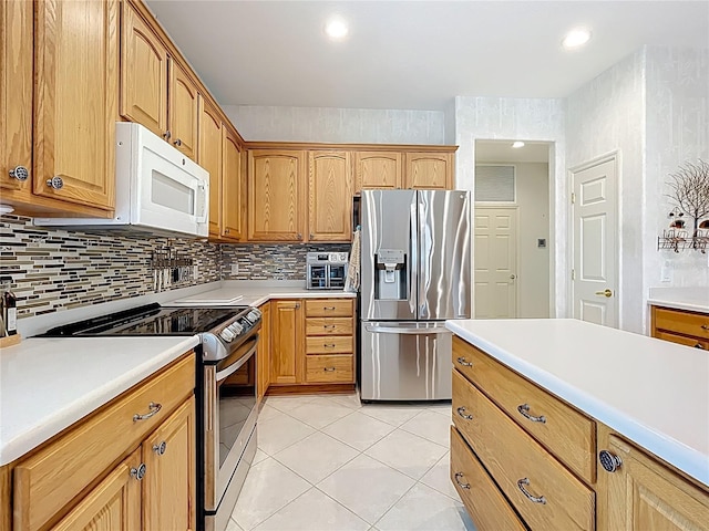 kitchen featuring tasteful backsplash, light tile patterned floors, light countertops, and stainless steel appliances