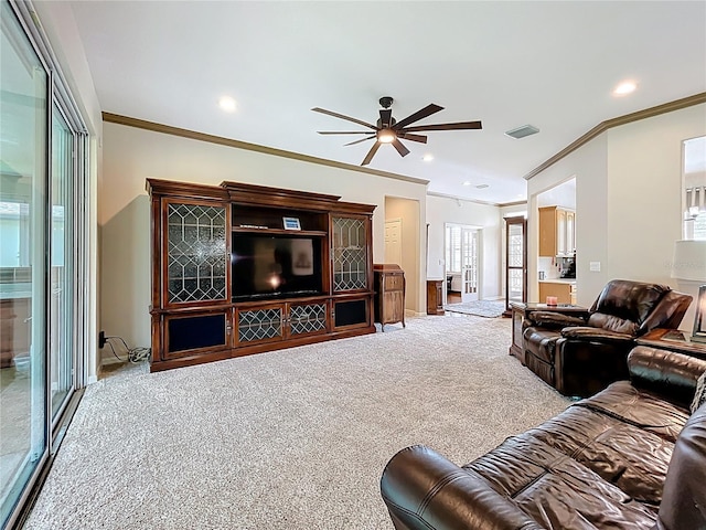 living area featuring visible vents, ornamental molding, a ceiling fan, recessed lighting, and carpet flooring