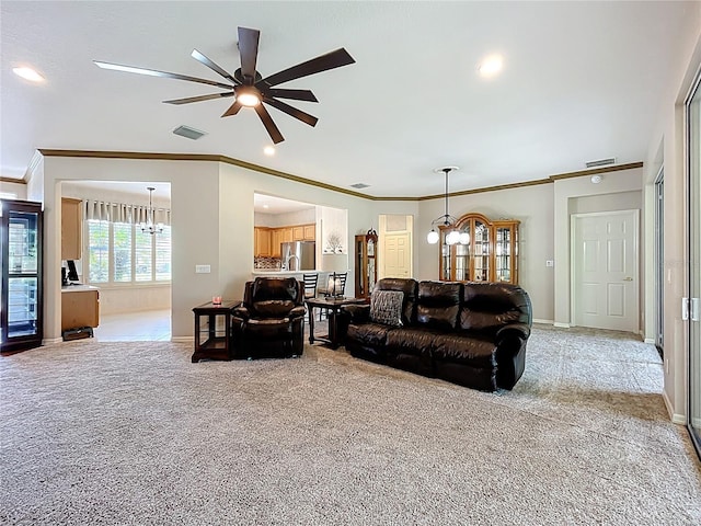 living room featuring crown molding, ceiling fan with notable chandelier, light colored carpet, and visible vents