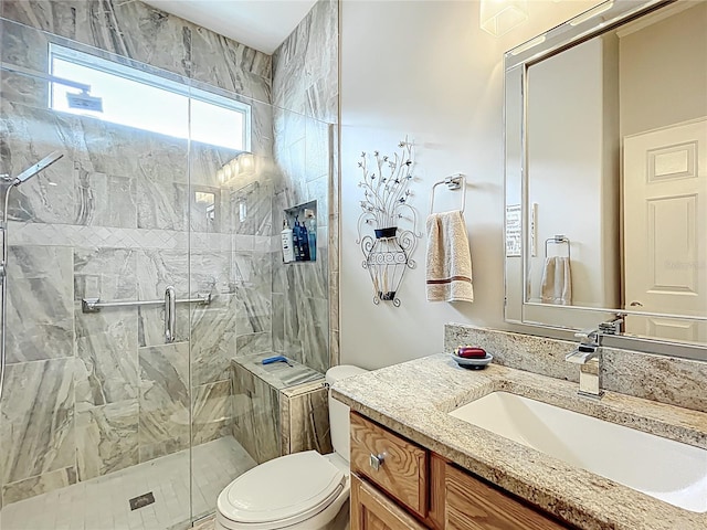 full bath featuring vanity, a stall shower, and toilet