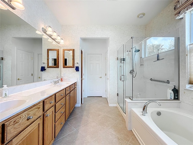 full bathroom featuring a shower stall, a bath, tile patterned flooring, a sink, and double vanity