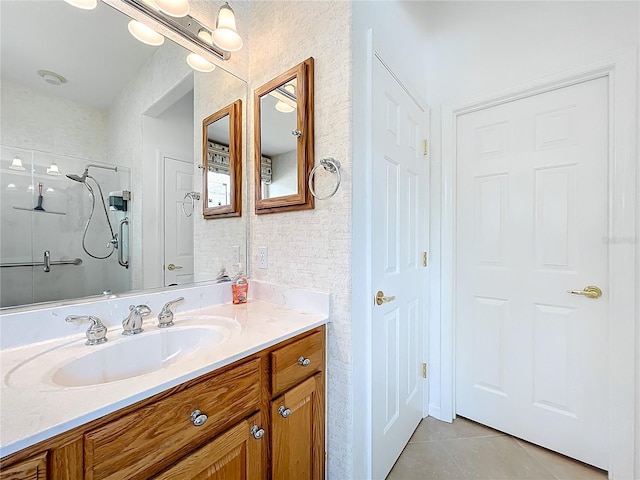bathroom featuring tile patterned floors, vanity, and a stall shower