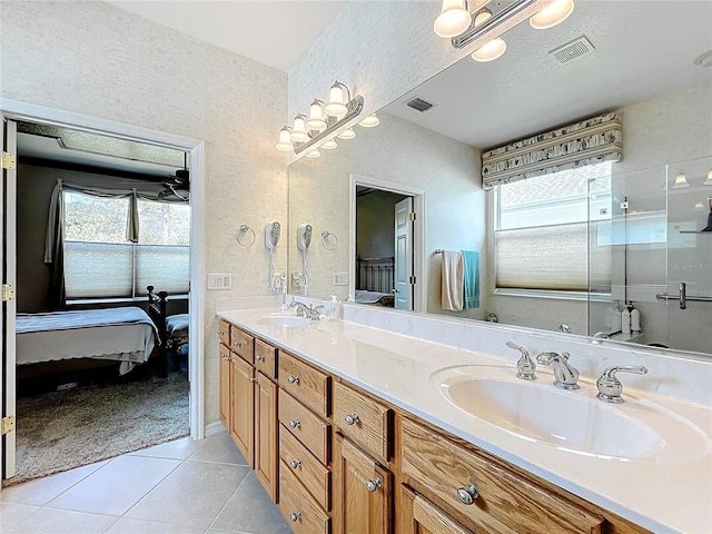 ensuite bathroom with visible vents, a sink, and ensuite bathroom
