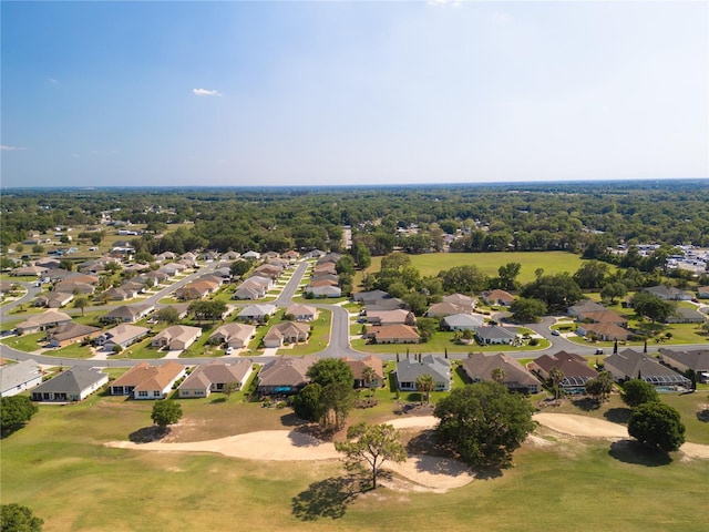 drone / aerial view with view of golf course and a residential view