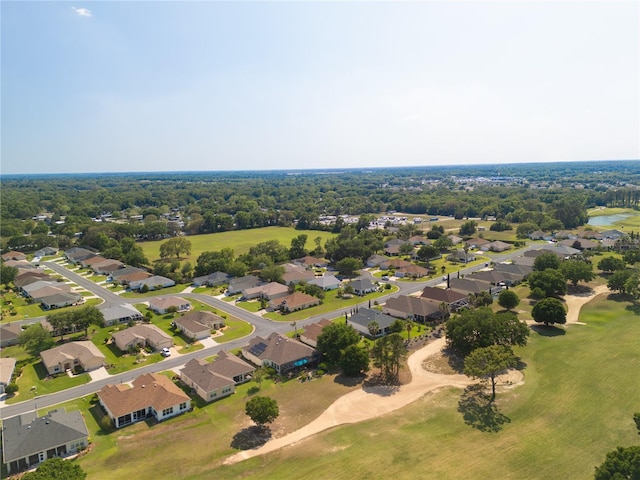 drone / aerial view with golf course view and a residential view