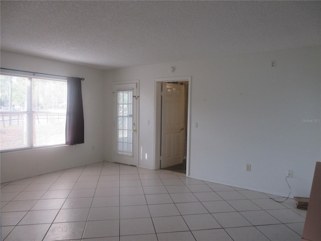 spare room with a textured ceiling